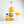 Load image into Gallery viewer, The small Passion Fruit Martini bottle is in the picture, alongside a large 750ml bottle. It is the same shape and similar label, but the bottle is a lot larger. Next to it is a glass of Passion Fruit Martini in a coupe. It looks perfectly level, a nice orange colour, and has a layer of foam on top. There is also a shot of Prosecco next to it in a shot glass. The background is white.
