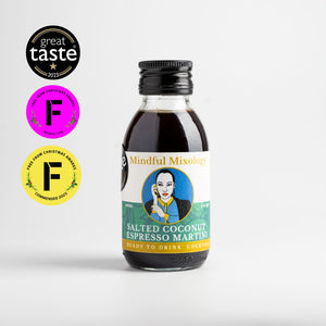 In the centre of the page is a single-serve cocktail in a cute looking small glass bottle, with a black aluminium cap. To the left of the page is a one star Great Taste award logo from 2023, and a purple and yellow logo from the Free From awards for Bronze and commended in 2022 and 2023. The cocktail is a Salted Coconut Espresso Martini and the label is green and white. In the centre is a circle and a picture which looks like Sade.